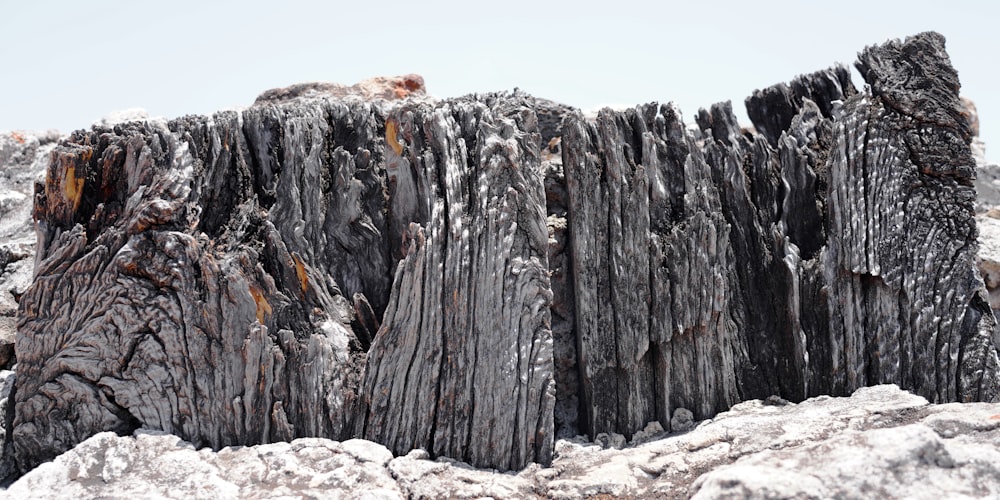 a large piece of wood sitting on top of a pile of rocks