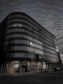 A modern office building in Neuquén city with a subtle dark overlay for text readability.