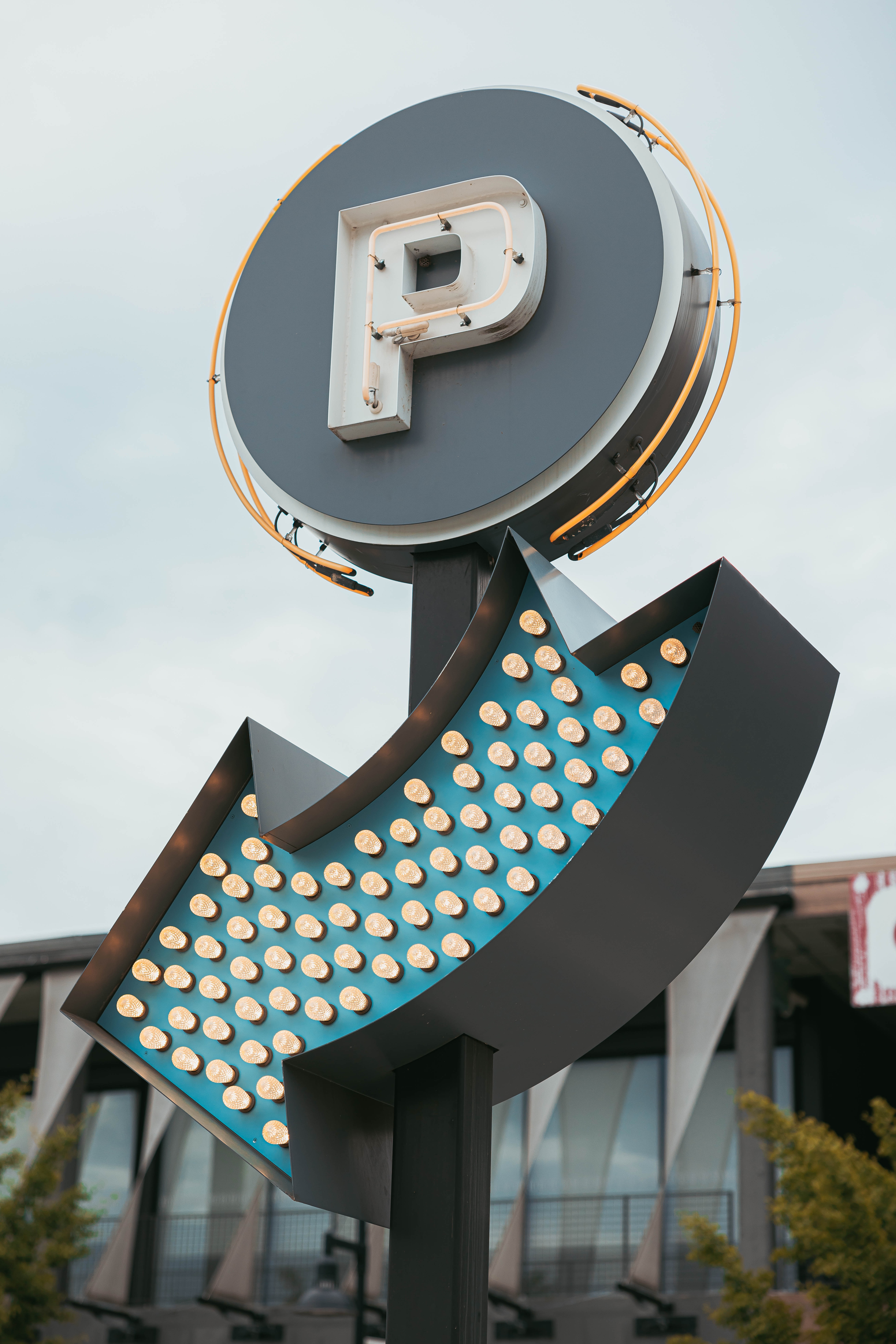 a parking sign with a lit up parking sign on top of it