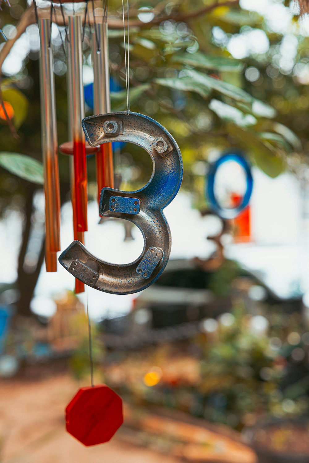 a metal number hanging from a tree