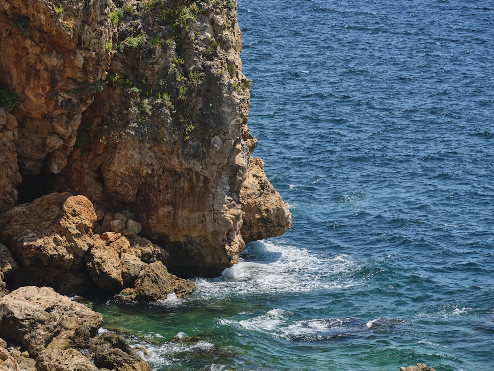 a rocky cliff overlooks a body of water
