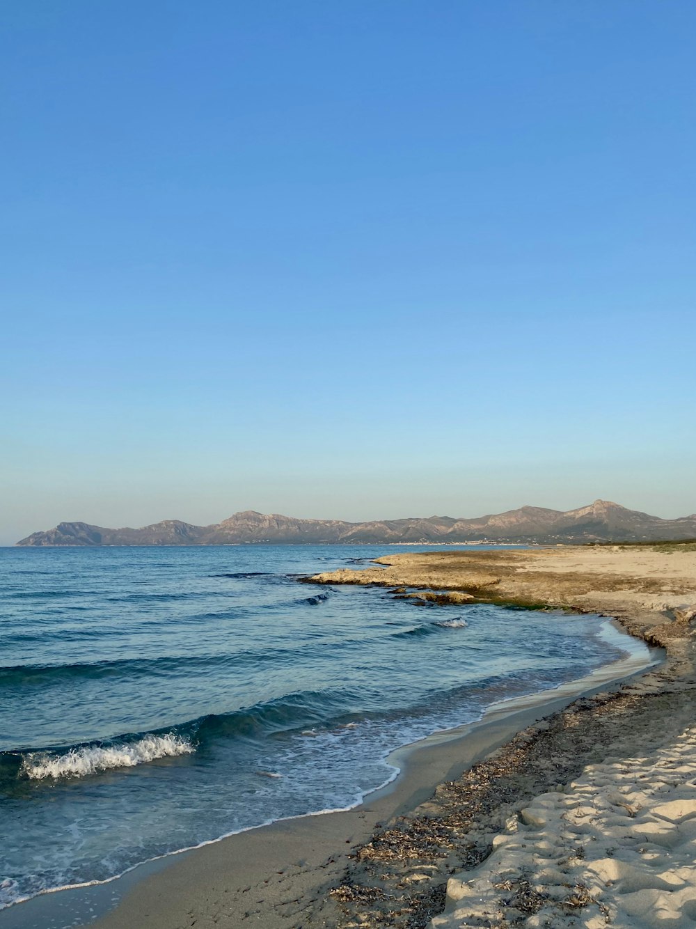 a view of the ocean from a sandy beach