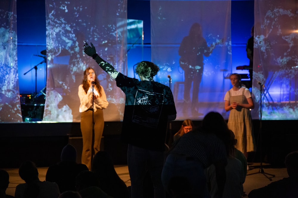 a group of people standing on top of a stage