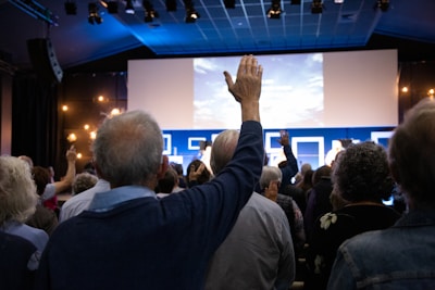 a group of people standing in front of a projection screen