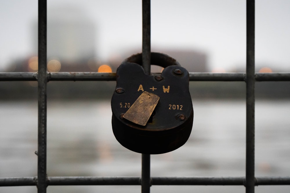 a padlock on a fence with a city in the background