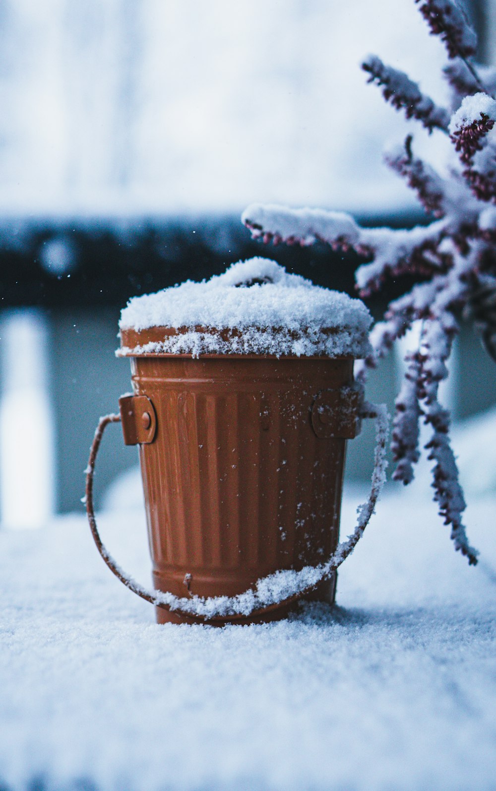 a cup of coffee is covered in snow