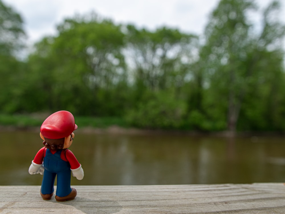 a toy figurine of a person wearing a red helmet