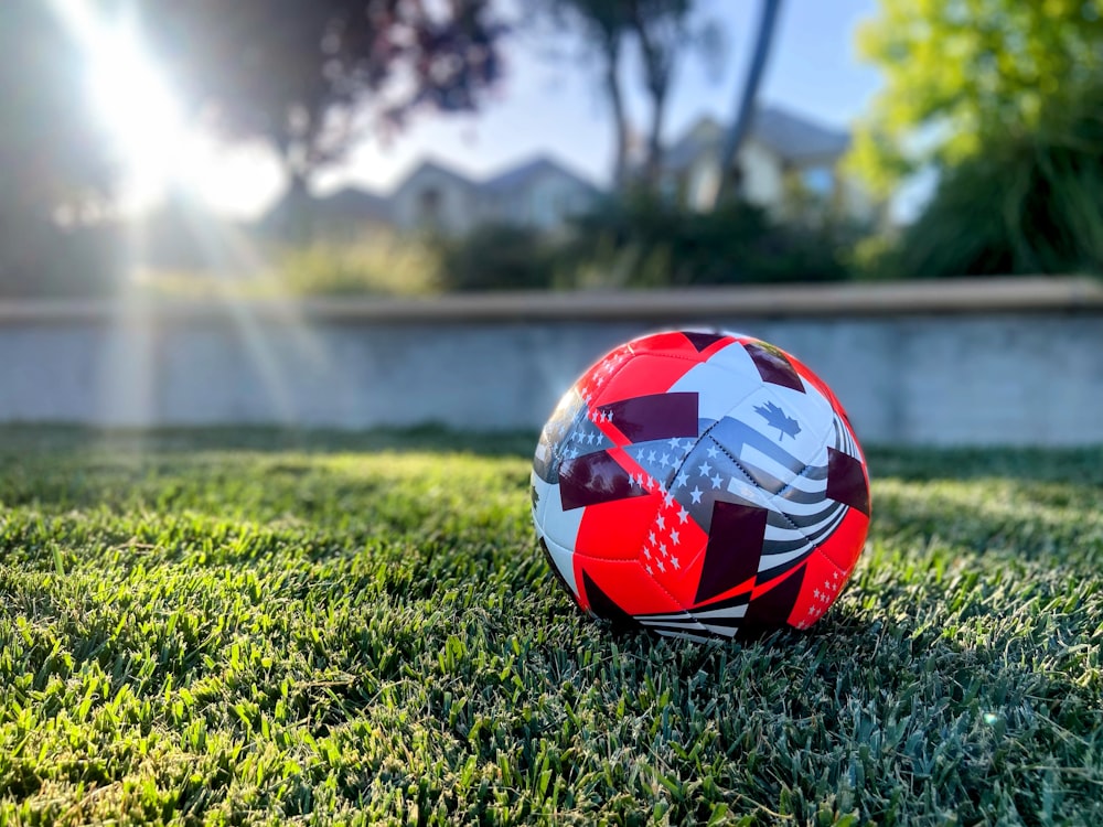 a soccer ball sitting on top of a lush green field