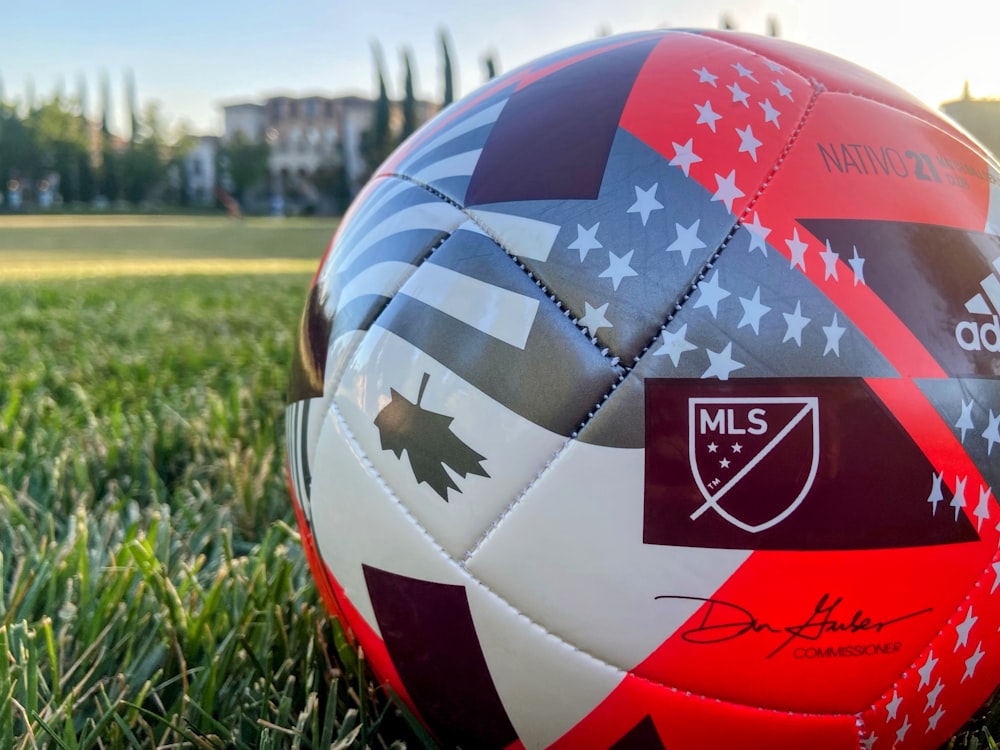 a soccer ball sitting on top of a lush green field