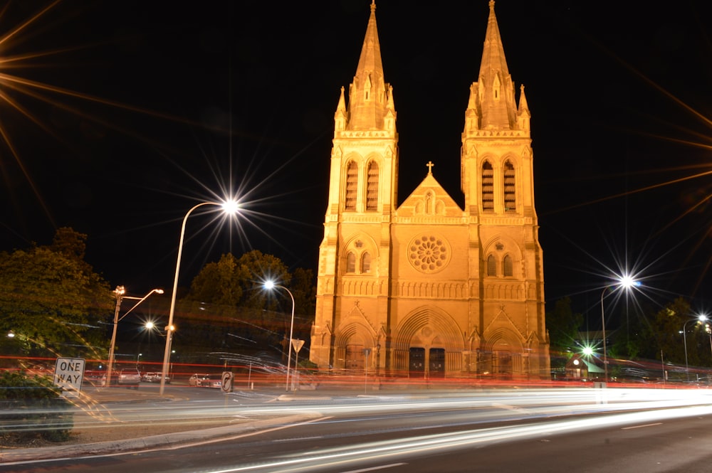 a cathedral lit up at night with street lights