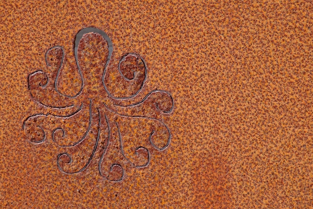 an intricate design on a rusted metal surface