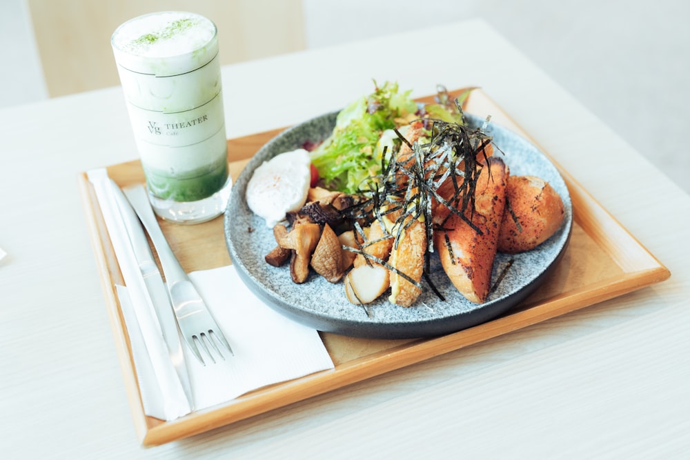 a plate of food on a wooden tray