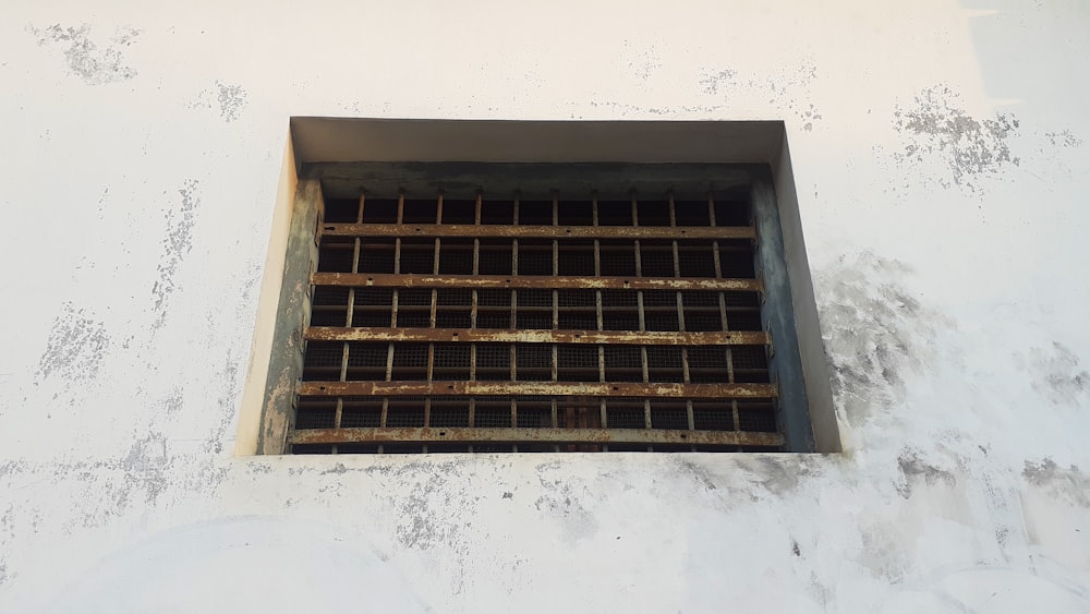 a grate in the side of a white building