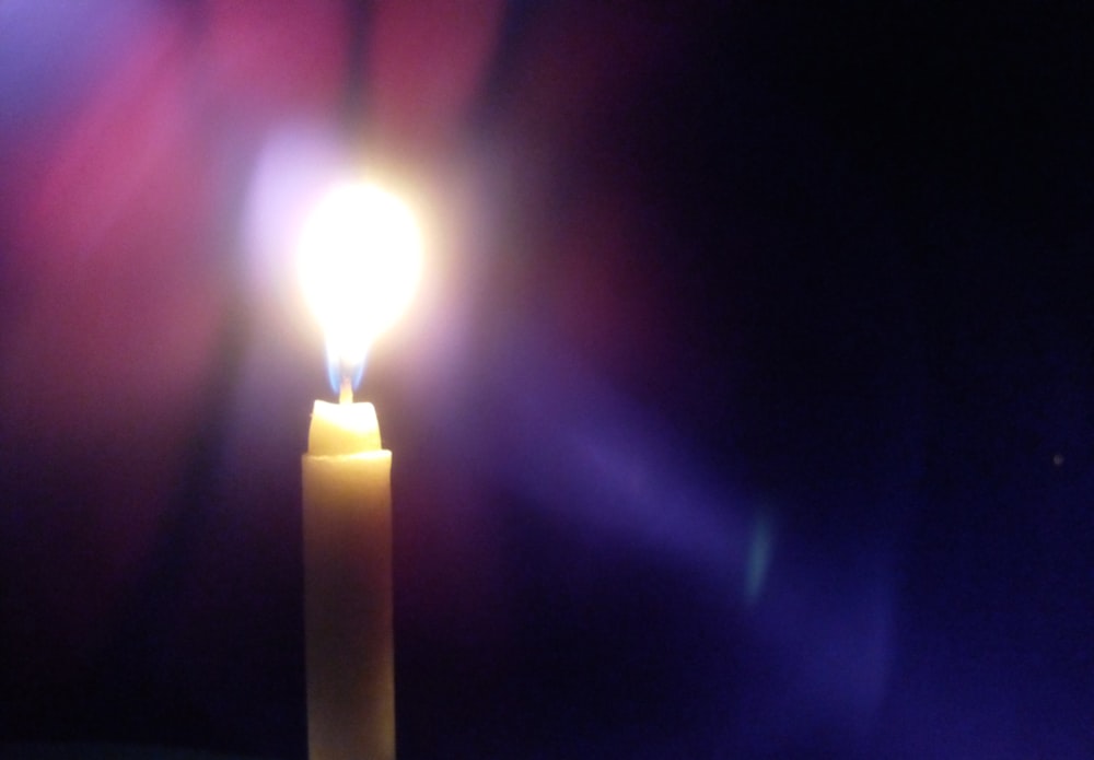 a candle with a bright light shining on it