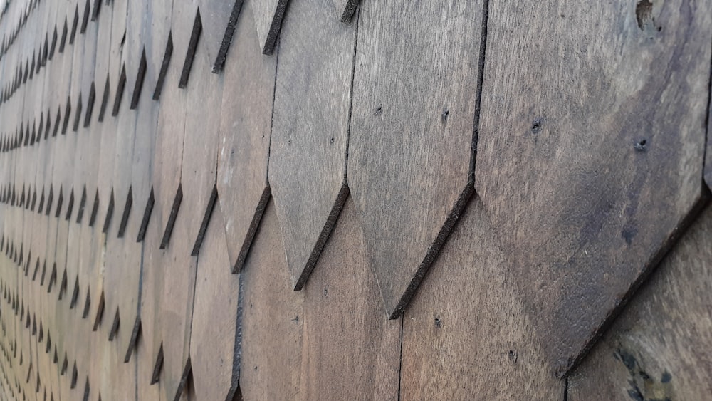 a close up of a wooden wall with nails on it