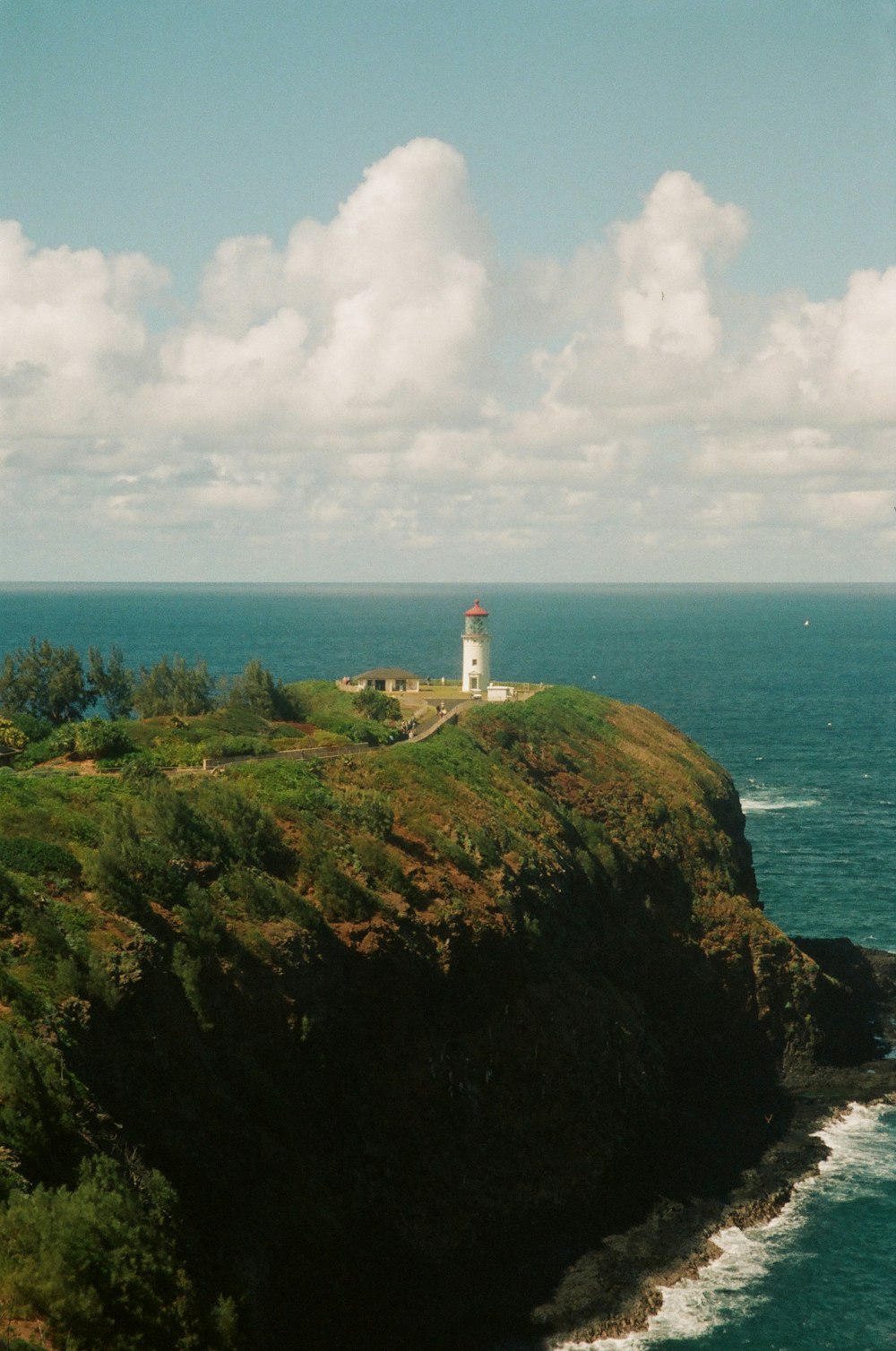 a lighthouse on a cliff overlooking the ocean