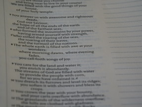 The image displays a page of printed text, likely from a religious or poetic work. The text includes numbered lines and discusses themes such as the power of God, nature, and creation. The right side of the page has a series of dotted lines running vertically.
