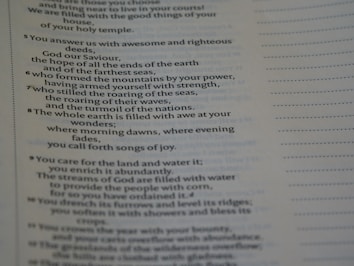 The image displays a page of printed text, likely from a religious or poetic work. The text includes numbered lines and discusses themes such as the power of God, nature, and creation. The right side of the page has a series of dotted lines running vertically.