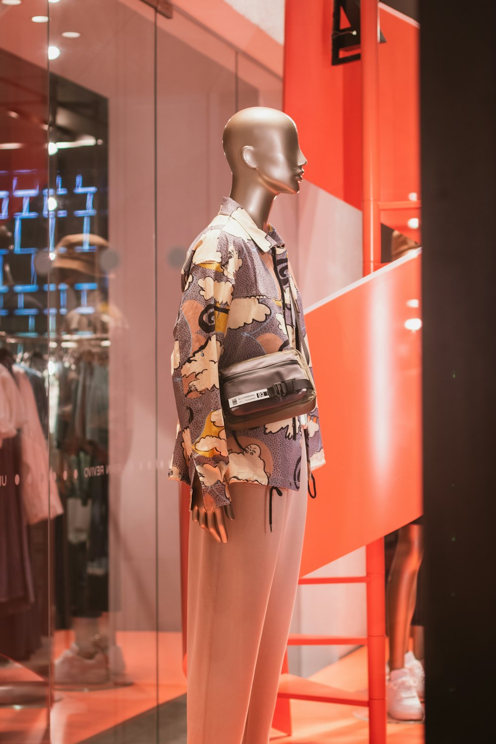 a mannequin in a window display of a clothing store