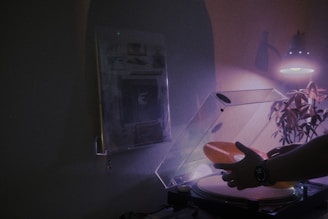 A moody studio corner with vinyl records and a turntable bathed in soft light.