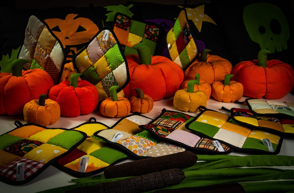 a table topped with lots of colorful pumpkins