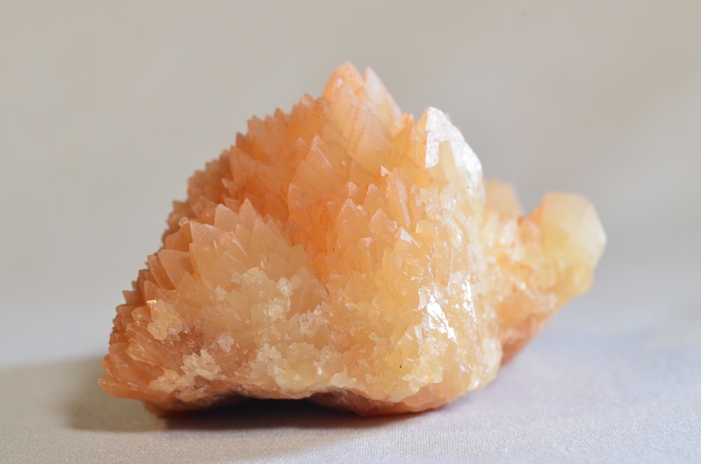 a close up of a piece of orange rock