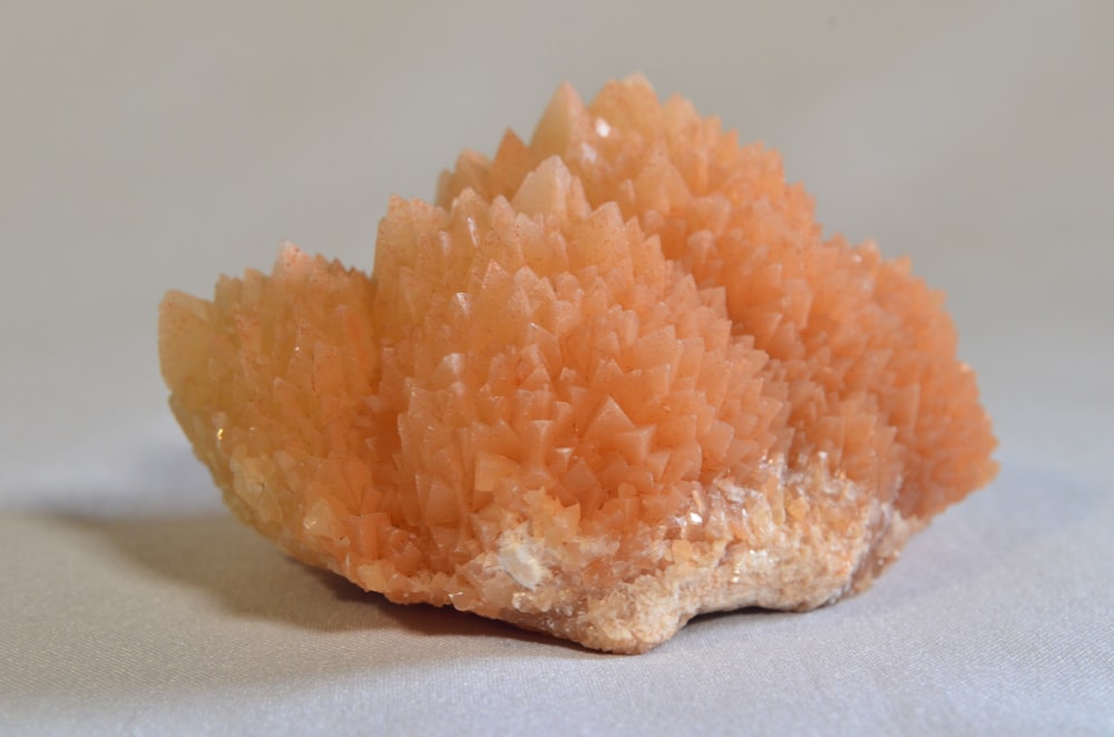 a close up of a piece of orange rock