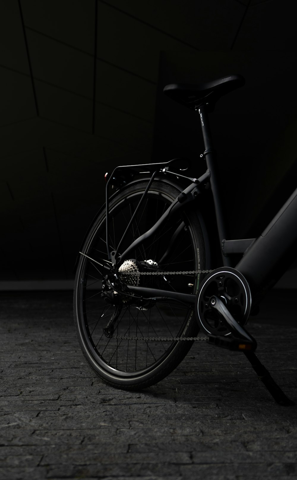 a bike parked in a dark room next to a wall