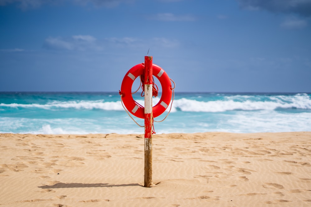 a life preserver sitting on top of a sandy beach