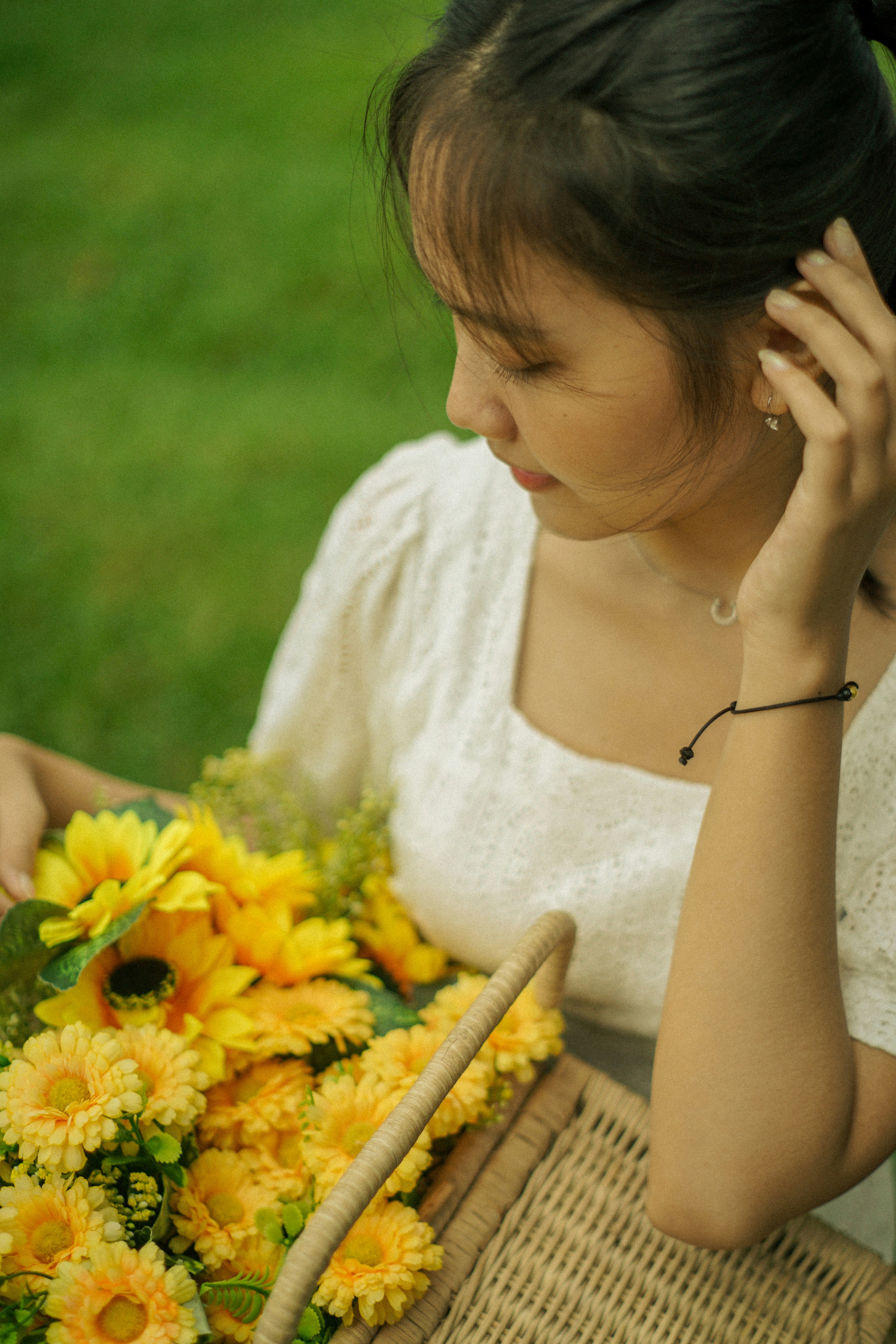 A woman holding a bouquet of sunflowers in her hand photo – Free Plant ...