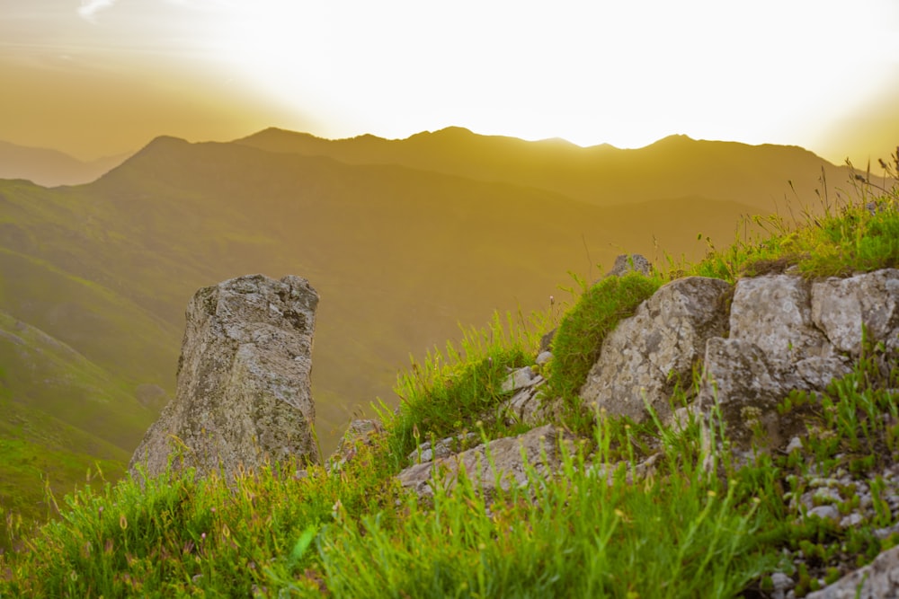 the sun is setting over a mountain range