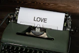 A vintage typewriter with a sheet showing the beginning of a heartfelt love story in Hindi.