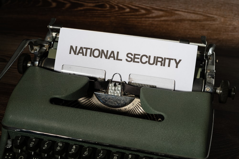 a close up of a typewriter with a national security sign on it