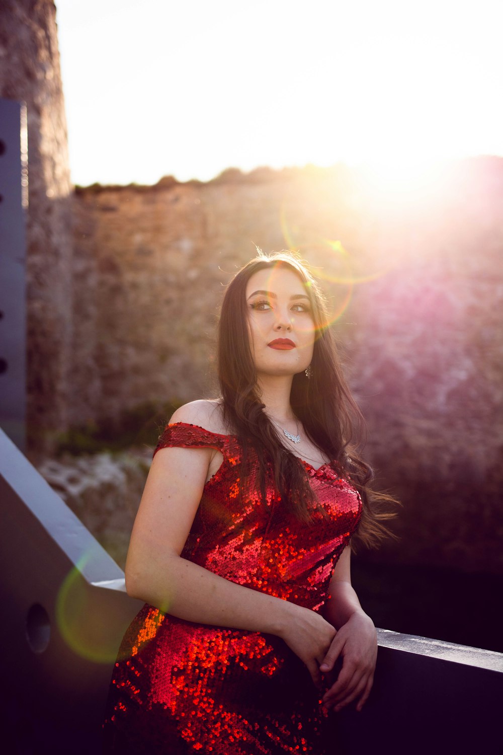 a woman in a red dress posing for a picture