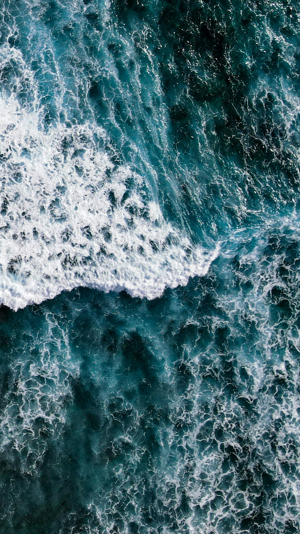 a person riding a surfboard on a wave in the ocean