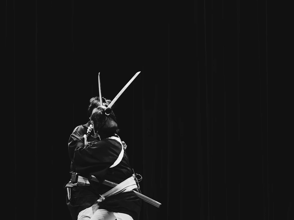 Black and white photo of a person holding a sword