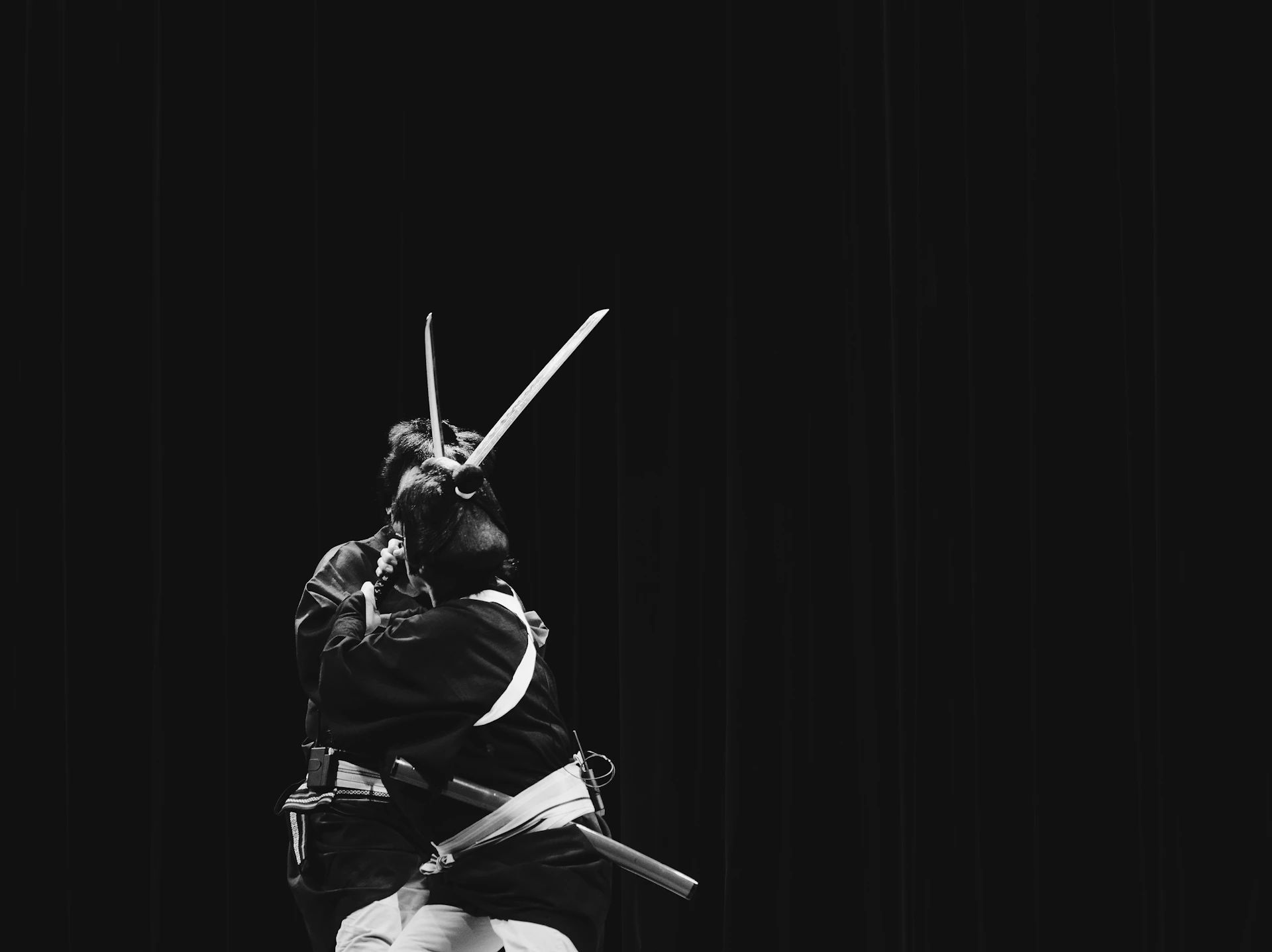 a black and white photo of a person holding a sword