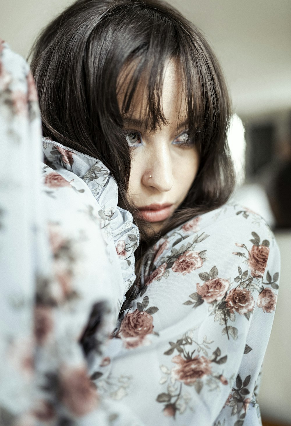 a close up of a person with a flowered shirt