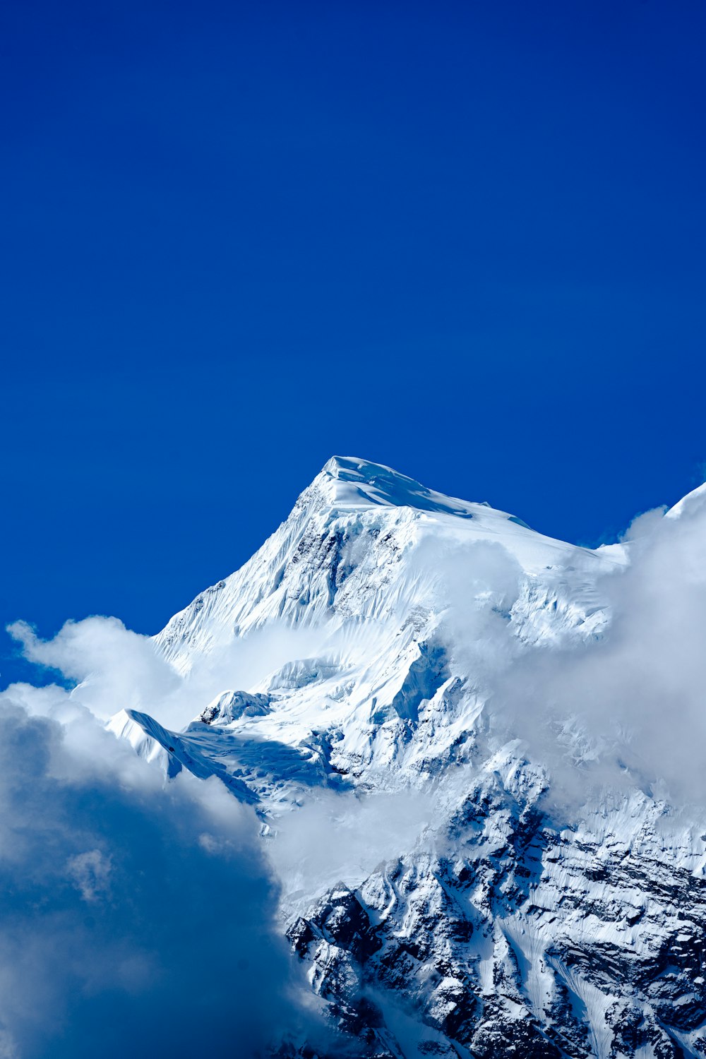 a snow covered mountain with a blue sky in the background