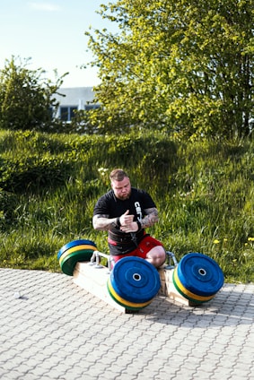 a man sitting on top of a wooden slide