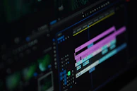 Close-up of cinematic wedding film editing on a computer screen with vibrant color grading.