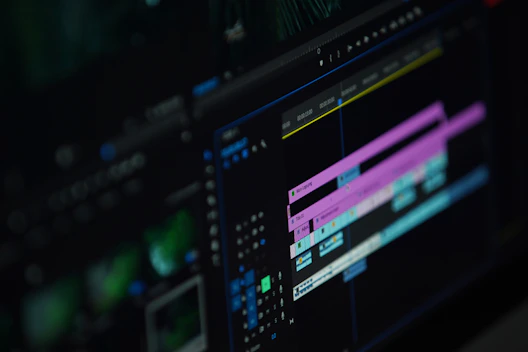 A close-up of hands editing a video timeline on a computer screen.
