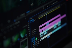 A close-up of a video editor working on a laptop.