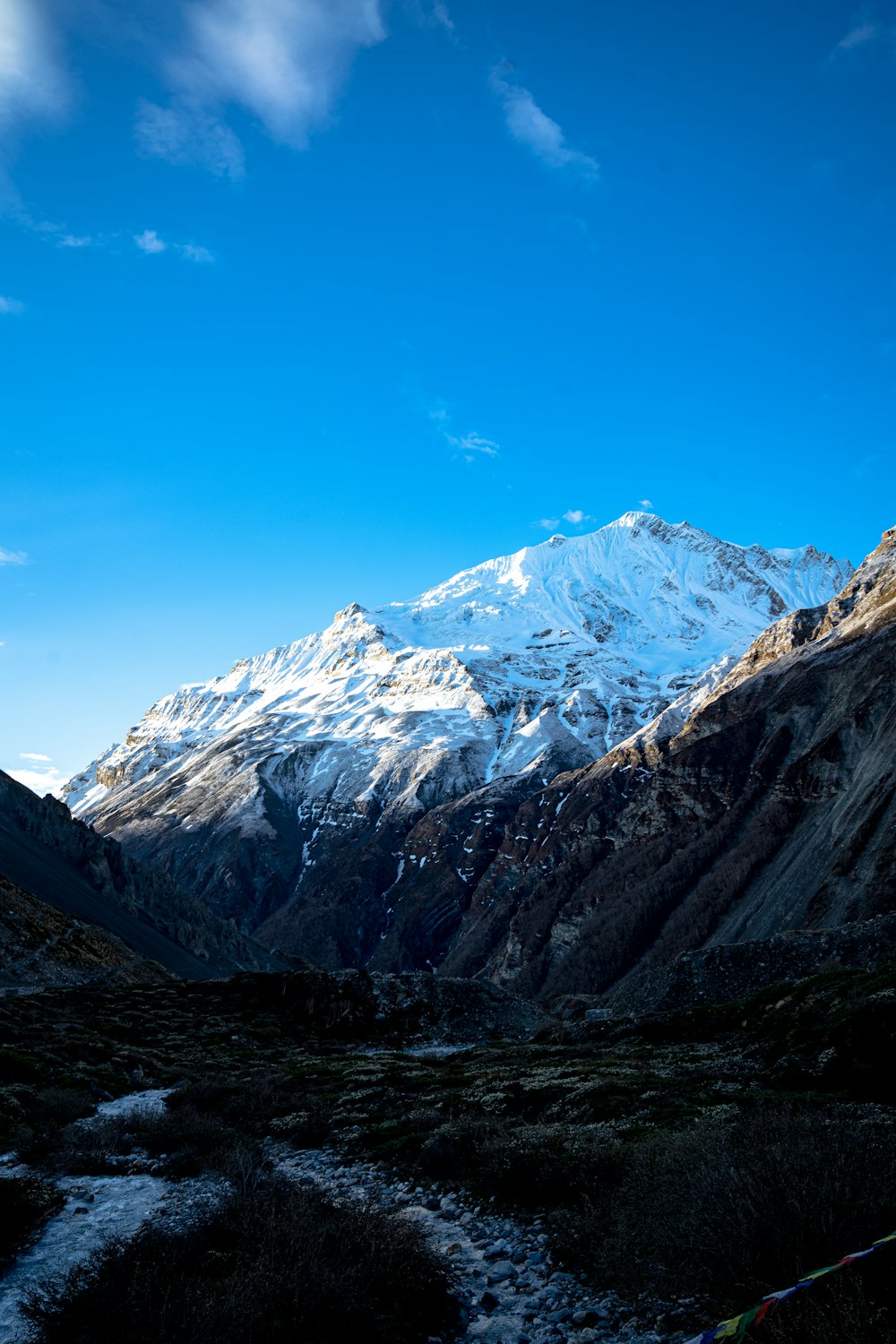 a mountain range with a stream running through it