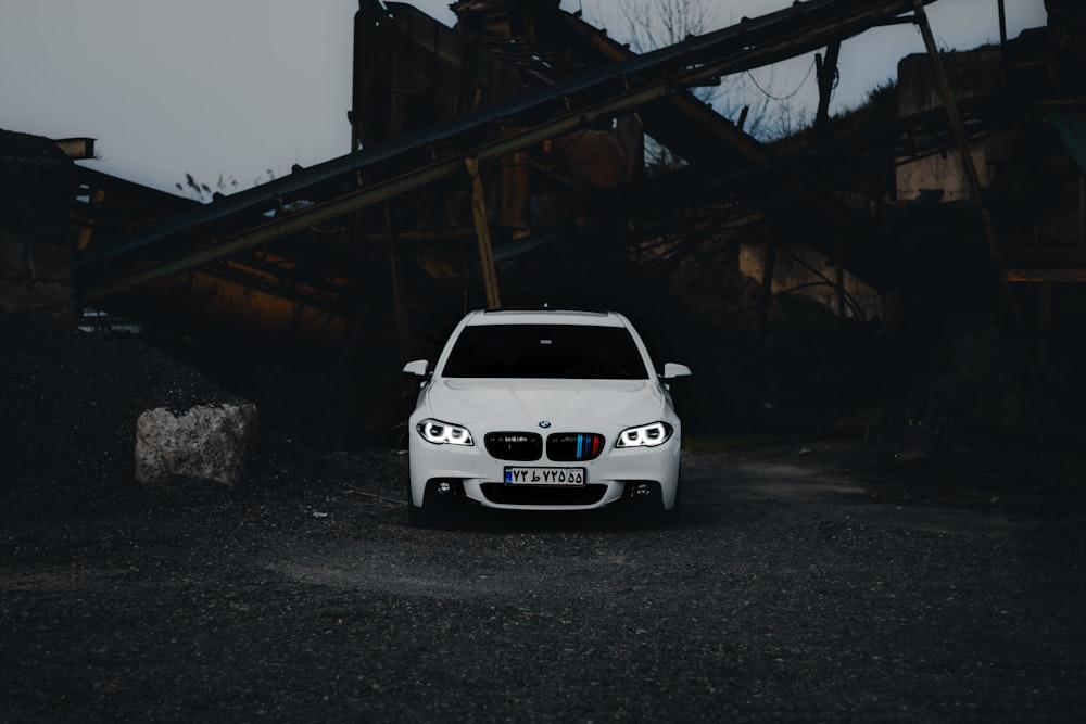 a white car parked in front of a building