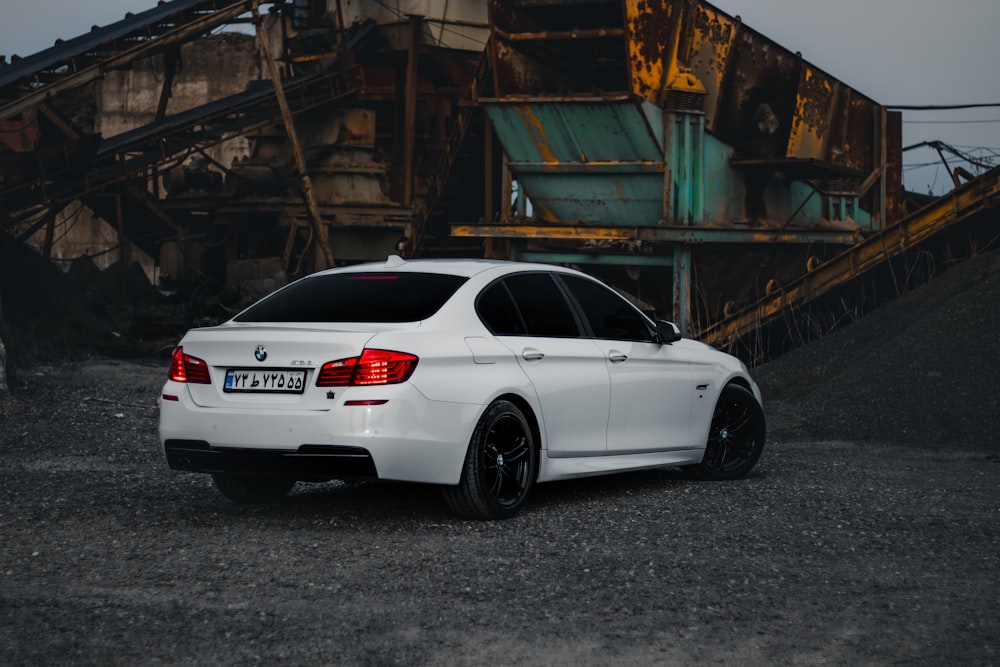 a white car parked in front of a building