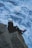 a man sitting on top of a rock next to a body of water