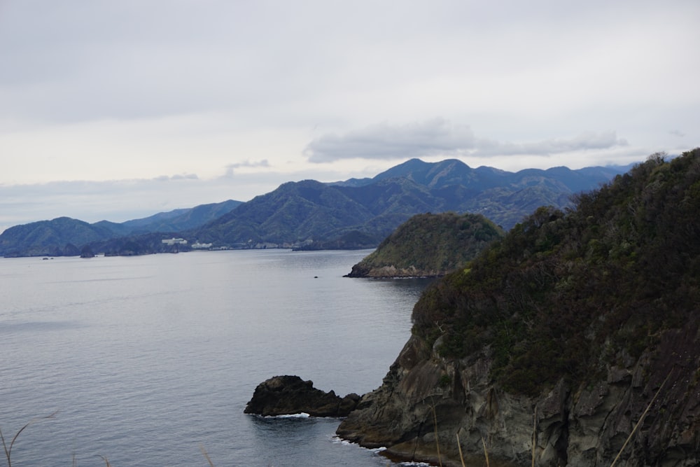 a body of water with mountains in the background