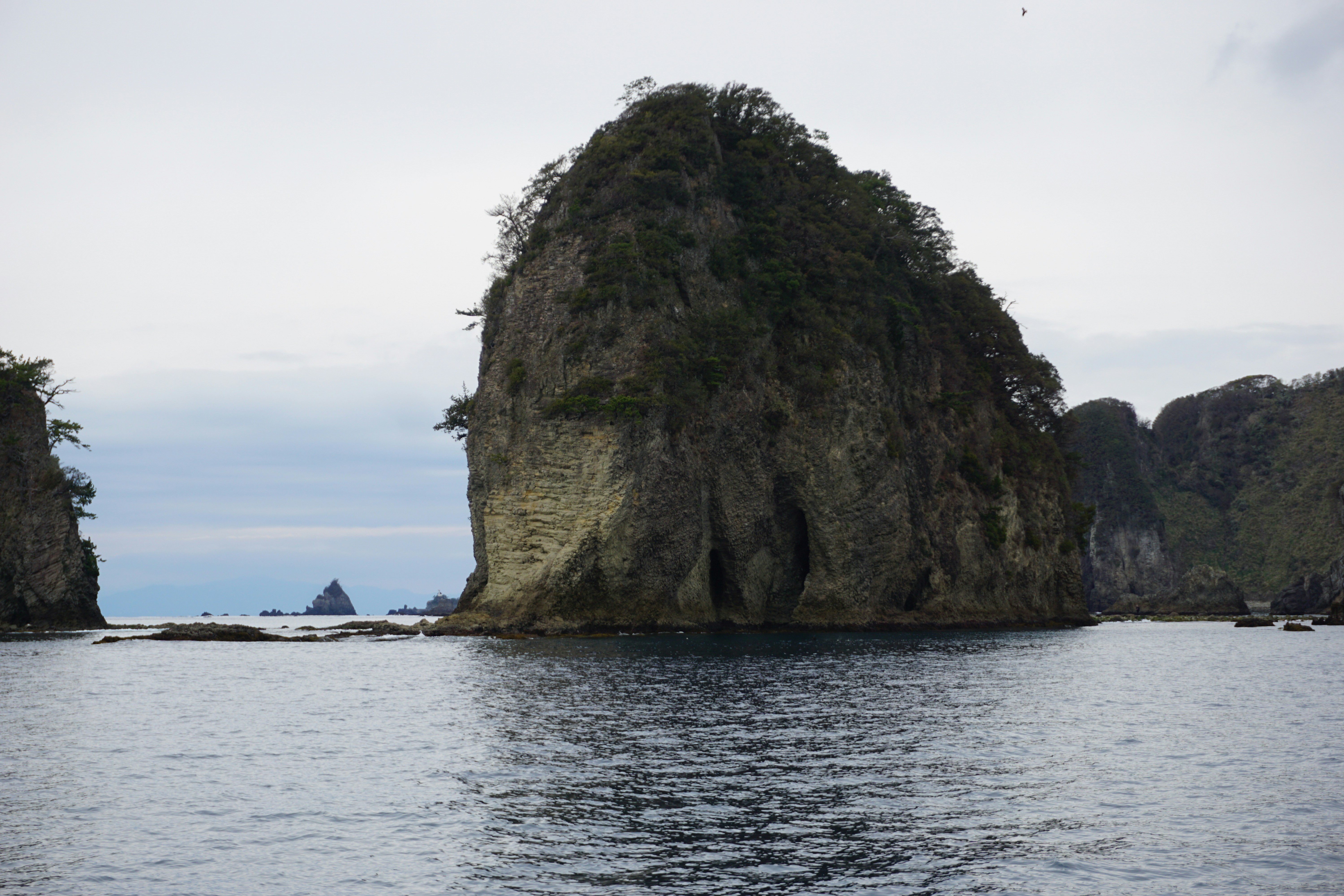 a large rock in the middle of a body of water