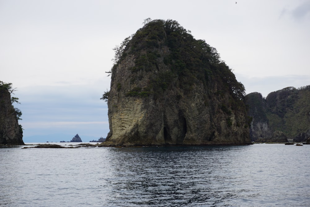 a large rock in the middle of a body of water